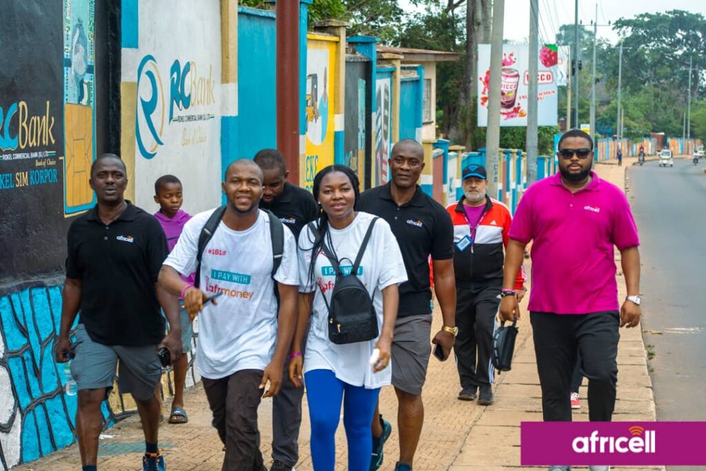 By Alusine Joseph Mansaray. The Africell Health and fitness walk was well attended by staff from various parts of the country as they started from the Africell headquarter at Wilberforce and designated to Leicester Peak on Saturday the 20th May 2023. Addressing the gathering at the finished point, the Chief Cooperate Affairs Manager of Africell Jose Abass Bangura said every employer knows that the most important assets to any company are their employees as the ultimate goal employers want from employees is to reach maximum productivity levels and in a quest to accomplish such supporting fitness is one of the most beneficial choices any employer can make to encourage their workers to reach their full potential. Joe Abass Bangura furthered that as a company they decided to organize the Africell health and fitness walk to improve employees’ health and wellness, reduce healthcare costs, and increase engagement and job satisfaction. Also, Joe Abass Bangura said during the health and fitness work the management of Africell provided some first aid treatments and as well vehicles for those whom might get hurt during the work but however thank God there was no casualty during the process. Mr. Bangura continued that this initiative will help employees not to get sick easily as when an employee uses less sick days, they contribute more to overall productivity and reduce the hassle of trying to find replacements at the last minute. He added that employees who are fit creates a sense of confidence, which allows them to set higher goals and to always strive for excellence and as well encouraging exercise is a good way to promote teamwork which encourages personal growth, increases job satisfaction, and reduces stress during and after work. On his path, the Media Manager of Africell, John Konteh said as a company they decided to embark on lots of sporting activities like the health and fitness walk, the LELEMU inter-departmental football tournament, the Sports meet and the Africell Freetown marathon as a way to keep their workers fit physically and psychologically which help reduces employees’ stress levels as a good exercise has the phenomenal ability to lessen the amount of stress felt from physical and emotional tensions in life. John Konteh furthered it is obvious that employees who are not stressed are more focused as they contribute to a much higher level of productivity. Similarly, John Konteh said that involving in sport helps you stay in shape, teaches you how to organize your time, boosts friendships, and builds relationships with your peers and adults in and outside place. John Konteh added that as a company they are very passionate about sports as there are lots of empirical evidences of their support to some of these sporting disciplines such as football, volleyball, crickets as the list goes on. John Konteh continued that the Africell inter-departmental LELEMU tournament will commence on Sunday the 28th May 2023 at the SS camp X-tray Arena and therefore called on their valued subscribers to witness football at its best as they have talented players which have the skills and enthusiasm to play football. John Konteh concluded by thanking all those that made it humanly possible to attend this epoch-making Africell health and fitness walk initiative. The Africell health and fitness work was climax with a group photos and merriments in a quest to show gratitude for making this event a success. Africell is the leading telecommunications company in Sierra Leone that has invested in various sectors in the country such as entertainment, education, health, infrastructure etc. and as well gives local talents the platforms they deserve by bringing them to a wider audience.